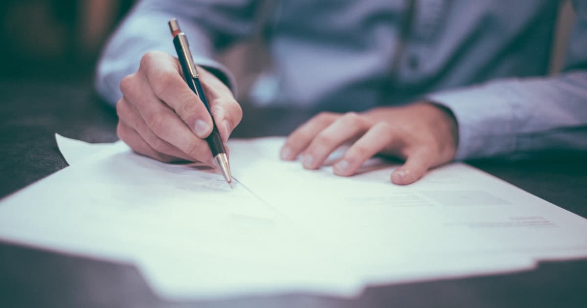 Entrepreneur reviewing LLC formation documents for a side project at a clean desk
